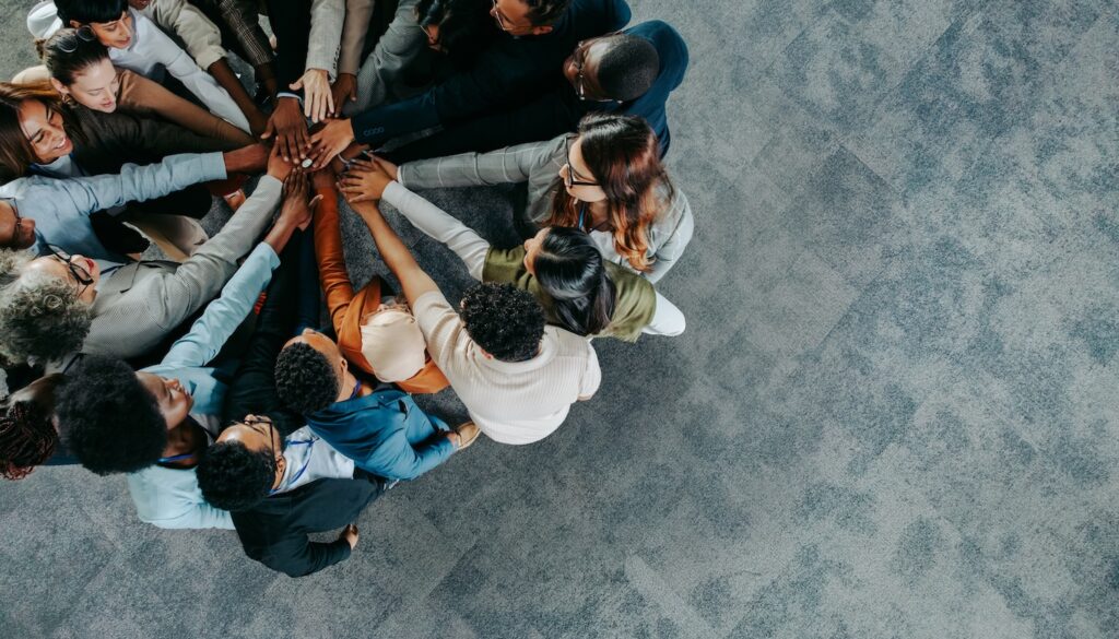 Employees gathered with hands together