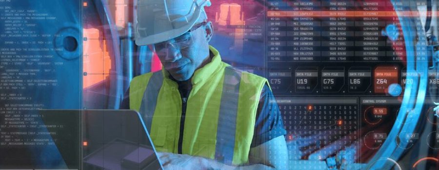 man in yellow vest and hard hat looking at computer